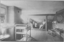 SA0496 - A museum-like room setting, showing a small loom and yarn winder plus two mannequins dressed as Shaker women., Winterthur Shaker Photograph and Post Card Collection 1851 to 1921c